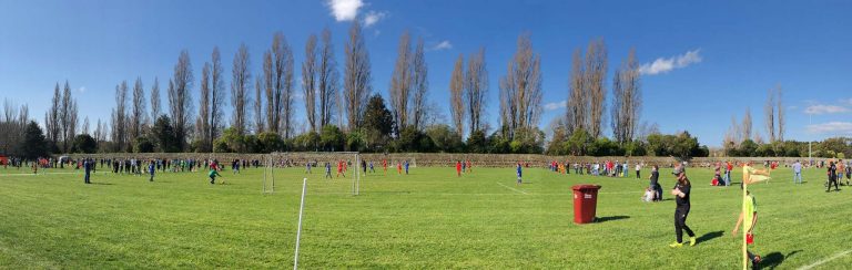 Sunny skis and beautiful green playing fields