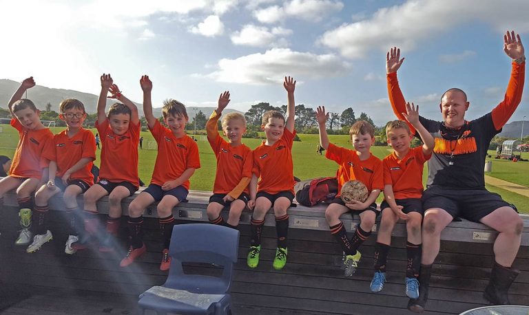 Players sitting on the deck at Hutt Park